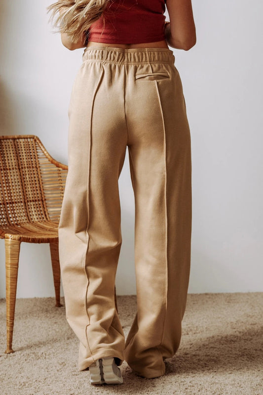 Pantalones anchos de cintura alta con cordón ajustable y costuras expuestas en gris humo