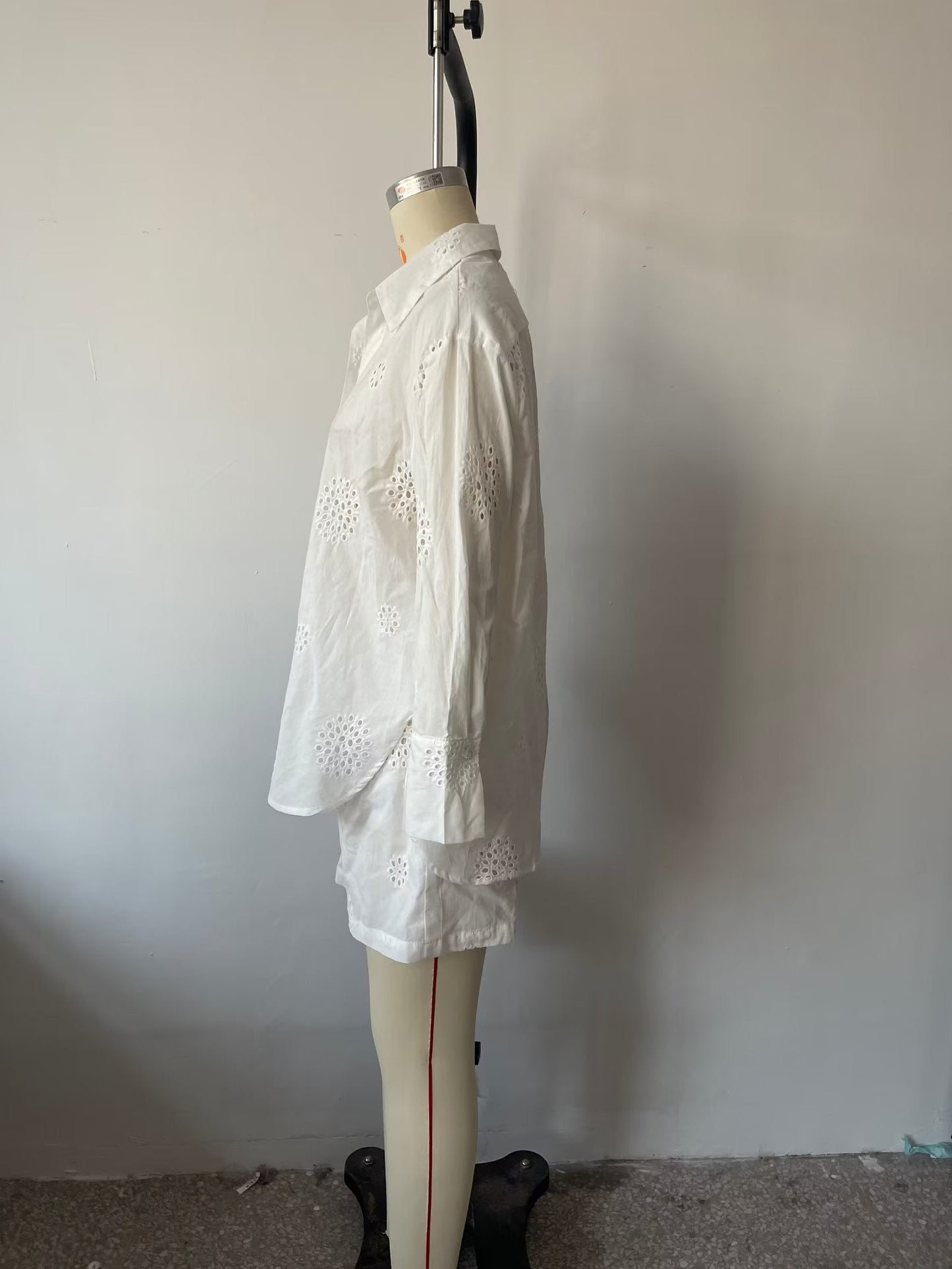 Traje informal blanco con escote en V, camisa bordada de media manga con aberturas y cintura alta, pantalones cortos informales con aberturas y aberturas.