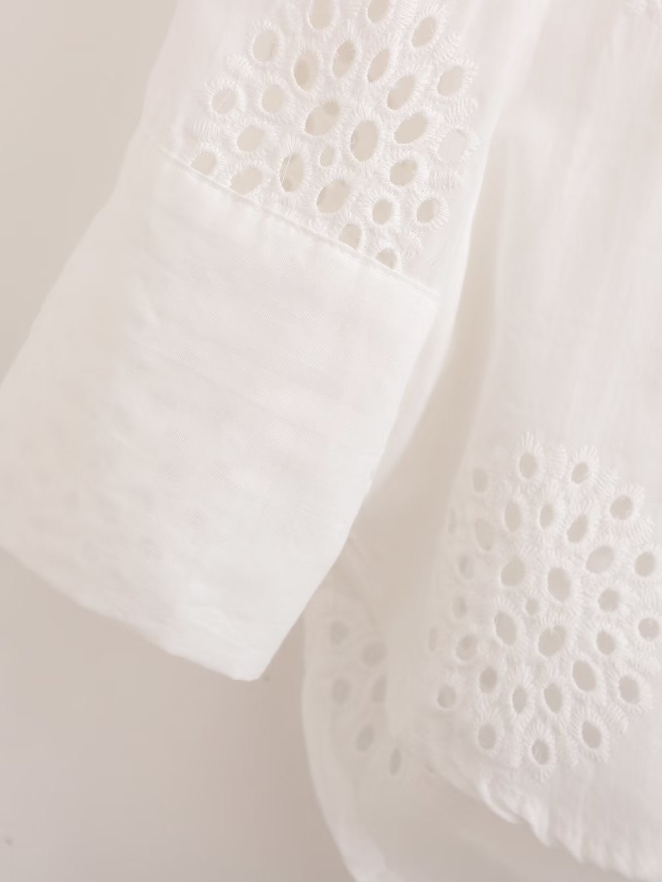 Traje informal blanco con escote en V, camisa bordada de media manga con aberturas y cintura alta, pantalones cortos informales con aberturas y aberturas.