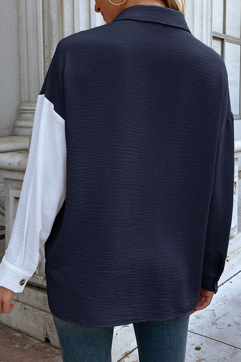 Elegante blusa con cuello vuelto y diseño de patchwork en bloques de colores