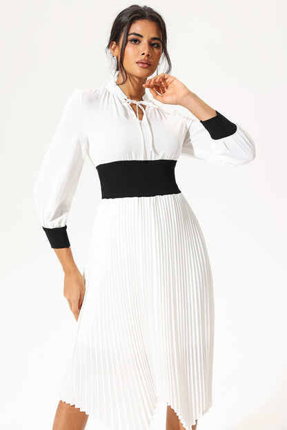 Vestido midi blanco con cinturón, cuello alto y mangas farol 