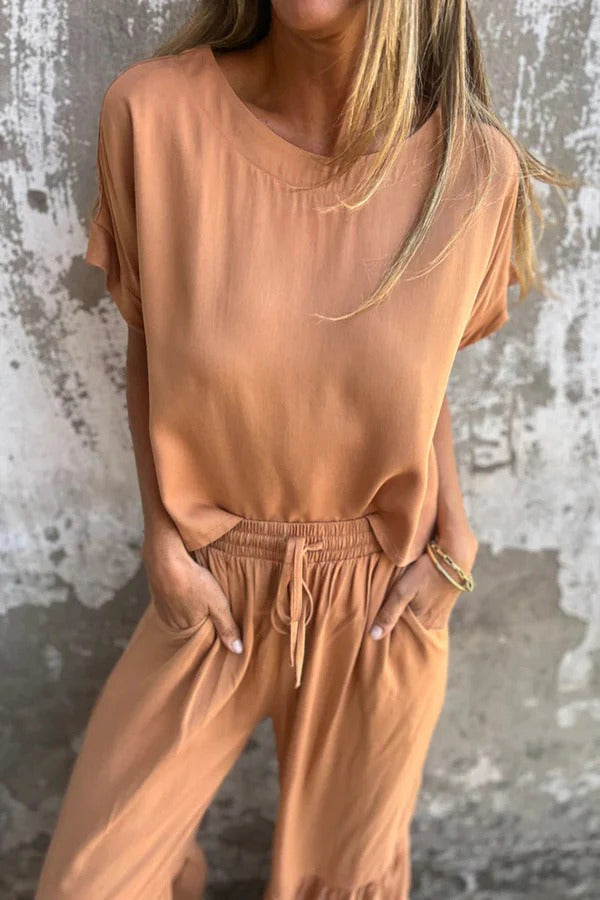 Conjunto de top casual de manga corta con cuello redondo y cintura elástica con bolsillo para atar y pantalones anchos de color liso