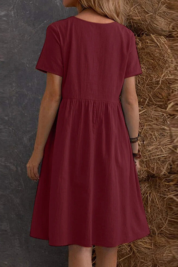 Vestido holgado de manga corta con cuello redondo y bolsillos en color liso