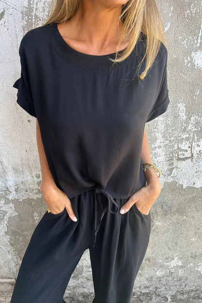 Conjunto de top casual de manga corta con cuello redondo y cintura elástica con bolsillo para atar y pantalones anchos de color liso