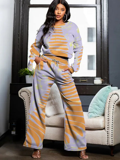 Conjunto de sudadera con bolsillo a rayas, pantalones con cordón y cuello redondo y manga larga: un conjunto elegante y cómodo.