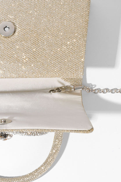 Bolso con asa de diamante y brillo metálico 