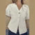 Chaleco de punto de moda para mujer, manga corta, cuello en V, botones, holgado, blanco, tipo cárdigan, otoño, novedad en prendas exteriores.