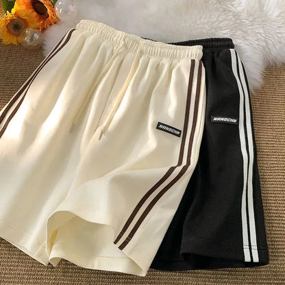 Pantalones cortos a rayas para mujer, ropa de calle de verano, pantalones cortos holgados de pierna ancha, pantalones cortos deportivos coreanos informales con cintura elástica, pantalones cortos de gran tamaño para parejas.
