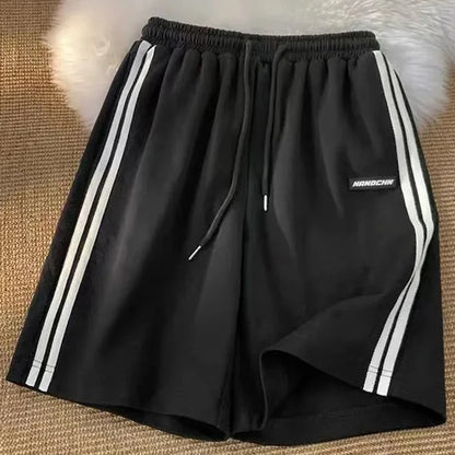 Pantalones cortos a rayas para mujer, ropa de calle de verano, pantalones cortos holgados de pierna ancha, pantalones cortos deportivos coreanos informales con cintura elástica, pantalones cortos de gran tamaño para parejas.
