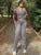 Conjunto informal de invierno de dos piezas con cárdigan de pierna recta y cremallera para mujer, y chándal ajustado de cintura alta con pantalones para mujer.