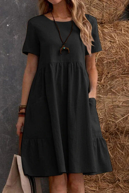 Vestido holgado de manga corta con cuello redondo y bolsillos en color liso