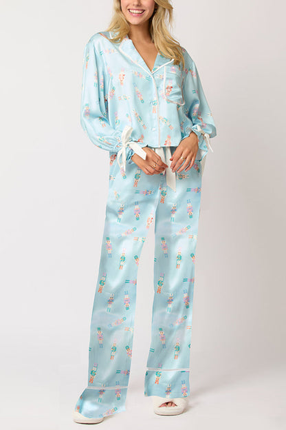 Conjunto de top de terciopelo con estampado navideño, manga larga, bolsillos y pantalones anchos con cintura elástica.