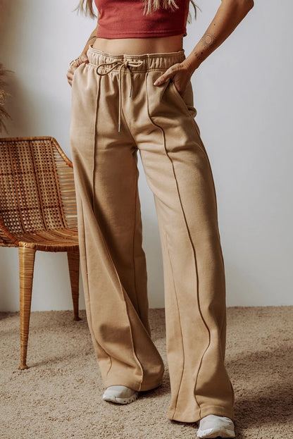Pantalones anchos de cintura alta con cordón ajustable y costuras expuestas en gris humo