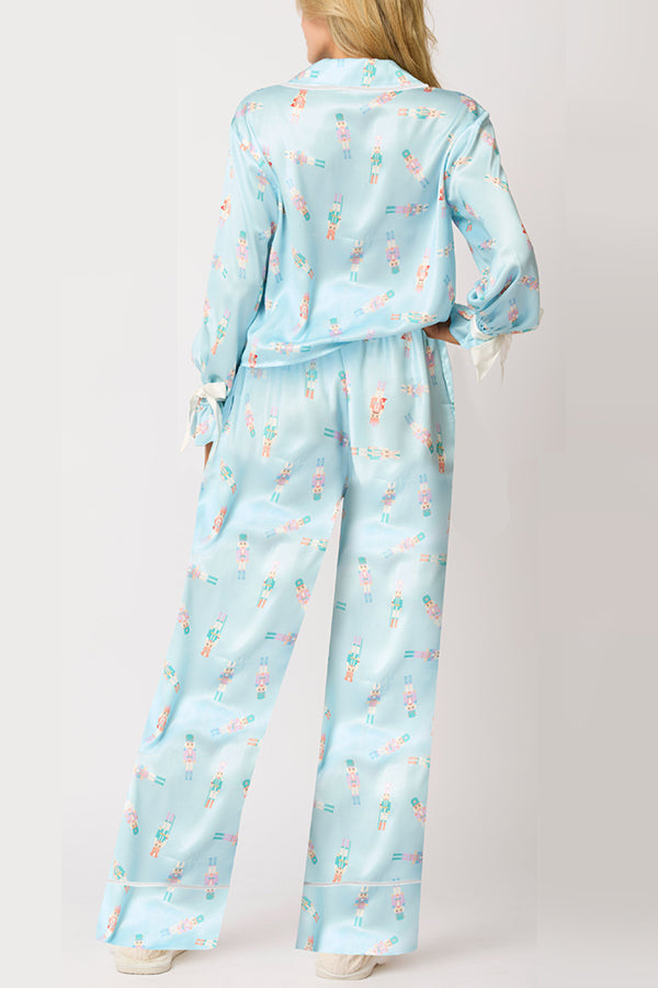 Conjunto de top de terciopelo con estampado navideño, manga larga, bolsillos y pantalones anchos con cintura elástica.