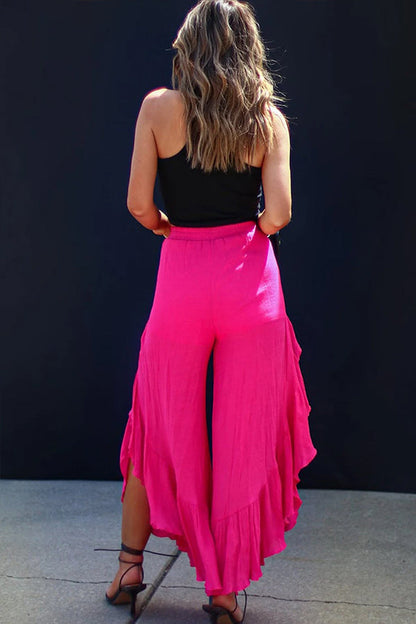Pantalones anchos de cintura alta con abertura y volantes de rosas