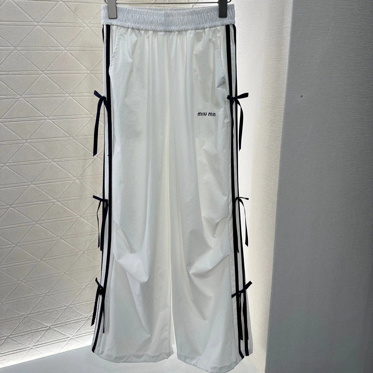 MIUMIU HIGH-WAISTED WIDE-LEG PANTS WITH BOW 276654