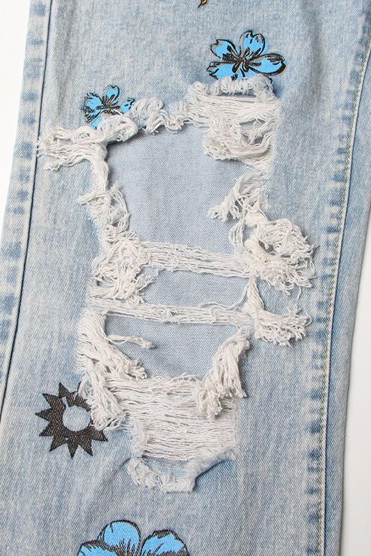 Vaqueros rotos con estampado floral y de sol de Liza 