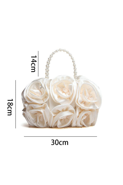 Bolso de mano con rosetas de satén y perlas 